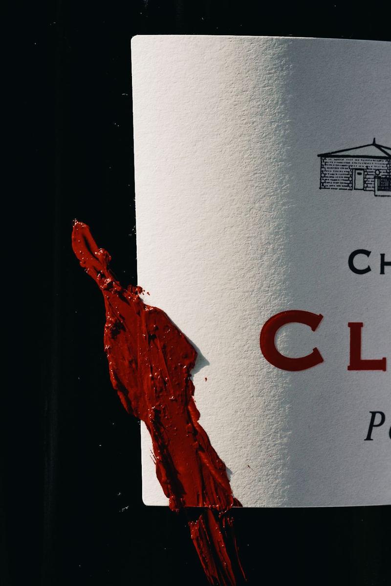 Close up chateau clinet wine label, half obscured and marked with red paint